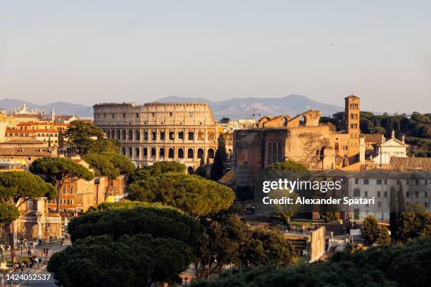 coliseum and rome skyline seen from above on a sunny day, italy - foro roma fotografías e imágenes de stock