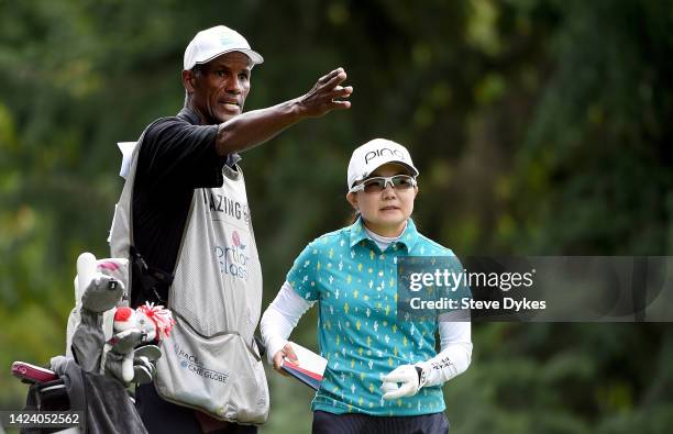 Ayako Uehara of Japan and her caddie size up her approach shot on the 13th hole during round one of the AmazingCre Portland Classic at Columbia...