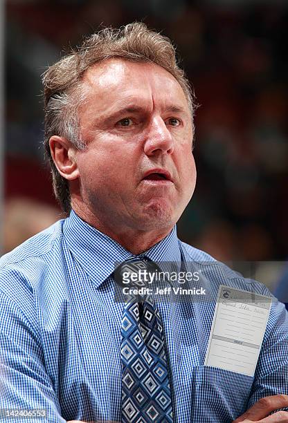 Associate coach Rick Bowness of the Vancouver Canucks looks on from the bench during their NHL game against the Los Angeles Kings at Rogers Arena...