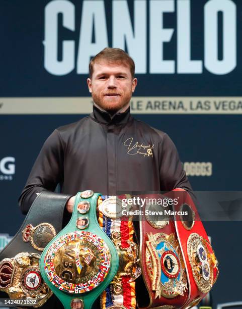 Undisputed super middleweight boxer Canelo Alvarez poses with his title belts during a news conference at the KA Theatre at MGM Grand Hotel & Casino...