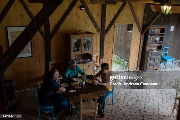 Tourists sit at the cafe in the house of King Charles III, which is open to visitors, on September 15, 2022 in Viscri, Romania. The village of Viscri...