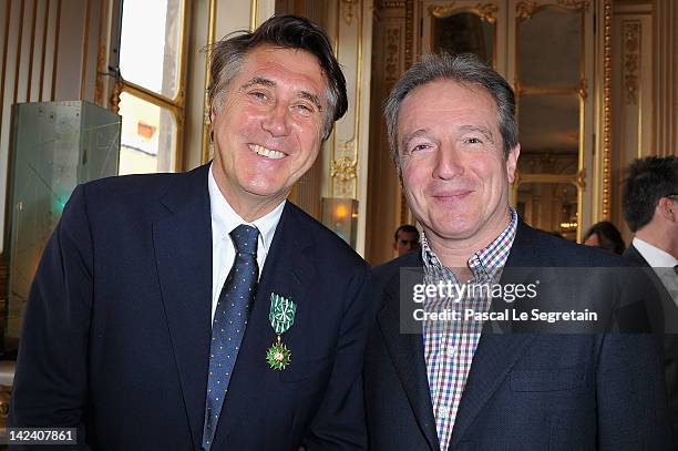 Bryan Ferry and Georges De Keerle pose at Ministere de la Culture on April 4, 2012 in Paris, France.