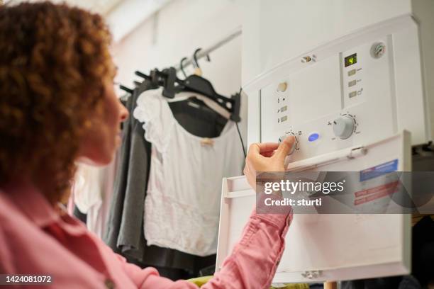 turning the boiler down - lowering stockfoto's en -beelden