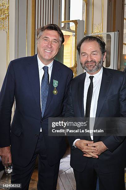 Bryan Ferry poses with Denis Olivennes at Ministere de la Culture on April 4, 2012 in Paris, France.