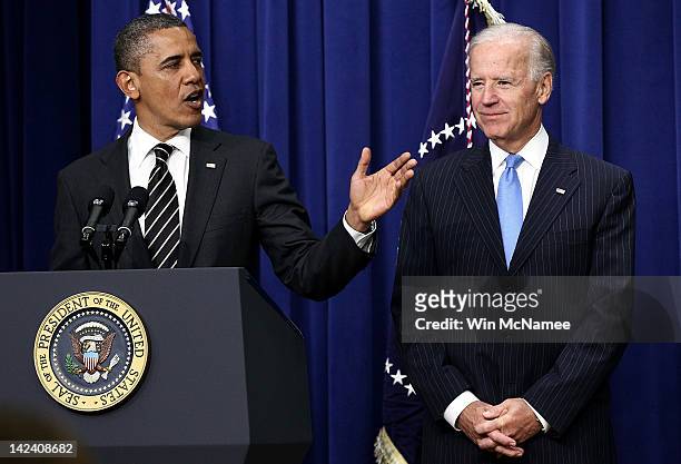 President Barack Obama speaks with U.S. Vice President Joe Biden before signing the STOCK Act into law at the Eisenhower Executive Office Building...
