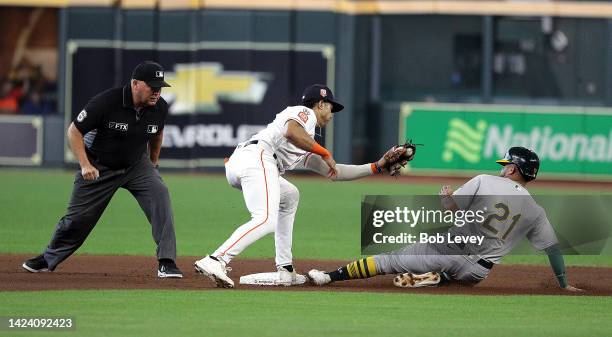 Vimael Machin of the Oakland Athletics steals second base in the first inning as Jeremy Pena of the Houston Astros applies the tag at Minute Maid...