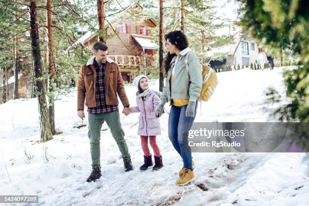 girl enjoying on the mountain with mom and dad - girl in winter coat studio stock pictures, royalty-free photos & images