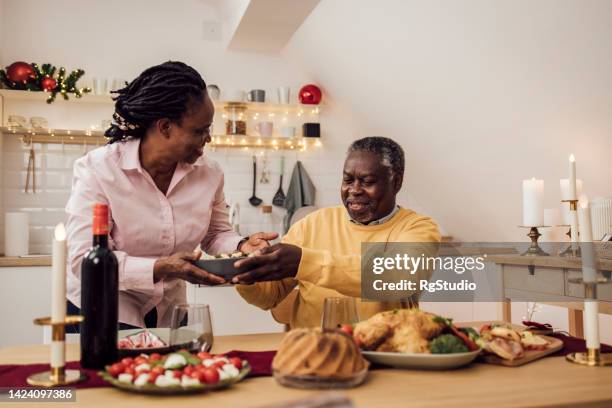 african american senior couple on their dinner for the new year's eve - 55 year old male stockfoto's en -beelden