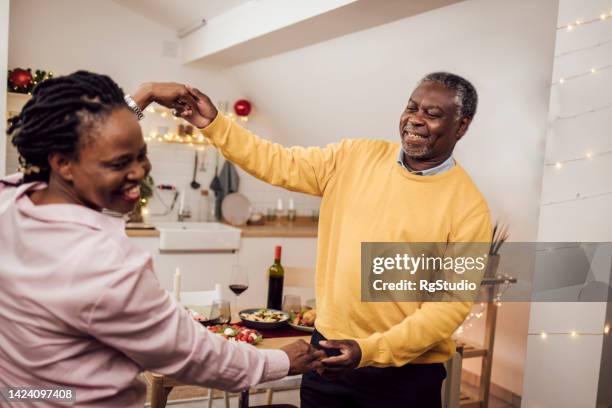 african american senior couple singing and enjoying together for the new year - senior man dancing on table stock pictures, royalty-free photos & images