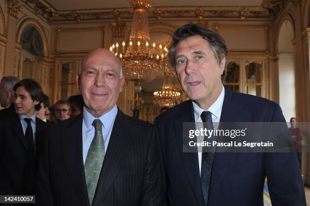 Bertrand Rindoff Petroff Officier des Arts et Des Lettres and Bryan Ferry pose at Ministere de la Culture on April 4, 2012 in Paris, France.