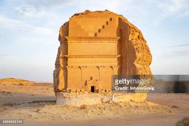 distant portrait of young middle eastern man exploring hegra - mada'in saleh stock pictures, royalty-free photos & images