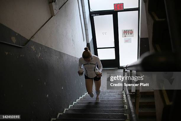 Female boxer Heather Hardy climbs up steps after getting coffee while training at Gleason's Gym on April 4, 2012 in New York City. Hardy, a 30 year...
