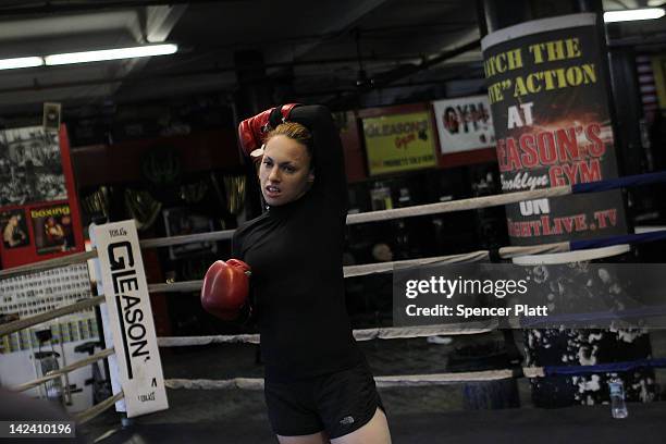 Female boxer Heather Hardy rests while training at Gleason's Gym on April 4, 2012 in New York City. Hardy, a 30 year old single mother who wants to...