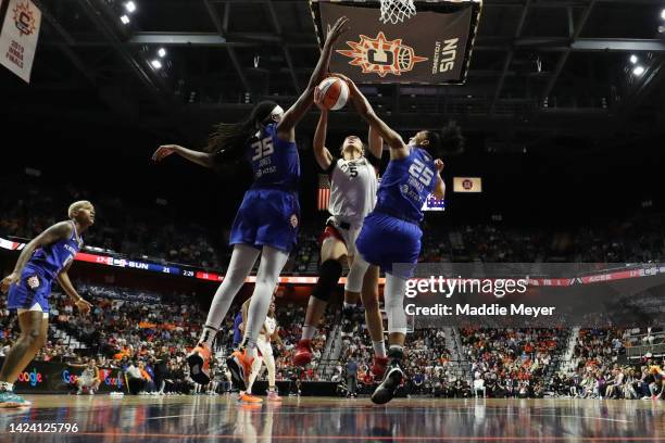 Dearica Hamby of the Las Vegas Aces attempts a shot between Jonquel Jones and Alyssa Thomas of the Connecticut Sun in the second quarter during Game...