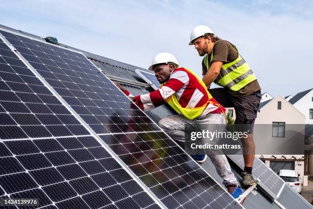 Workers Installing Rooftop Solar Panels High-Res Stock Photo - Getty Images
