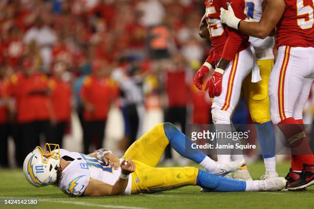 Justin Herbert of the Los Angeles Chargers lays on the ground after being hit during the fourth quarter against the Kansas City Chiefs at Arrowhead...