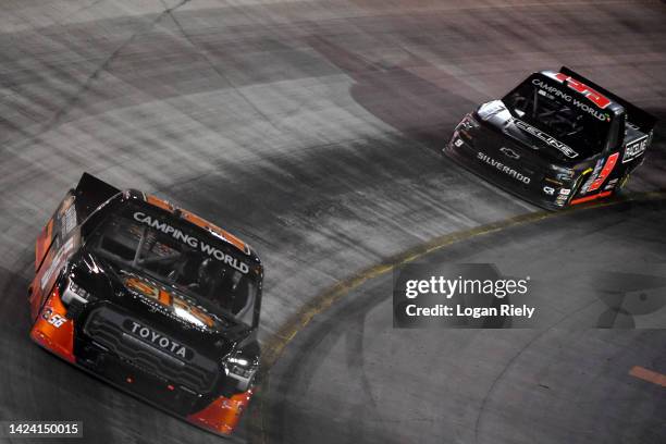 Timmy Hill, driver of the Southern Freight Services Toyota, and Blaine Perkins, driver of the RACELINE Chevrolet, race during the NASCAR Camping...