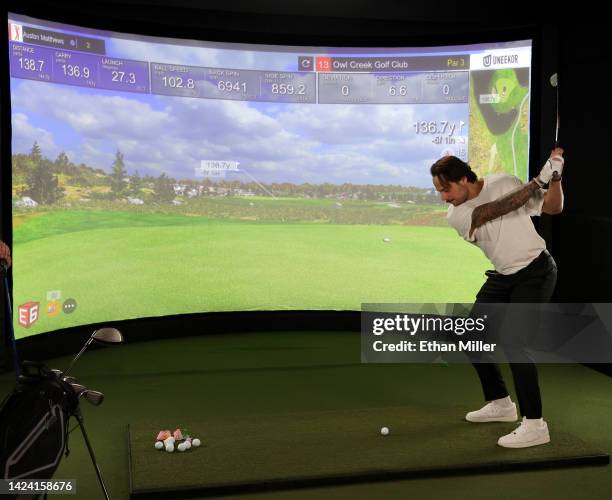 Auston Matthews of the Toronto Maple Leafs takes a swing at a golf simulator during the 2022 NHL player media tour at Encore Las Vegas on September...