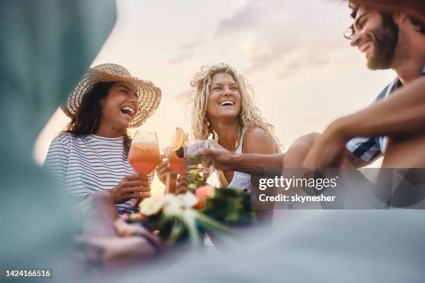 below view of happy friends toasting with cocktails in summer day. - cocktails stock pictures, royalty-free photos & images