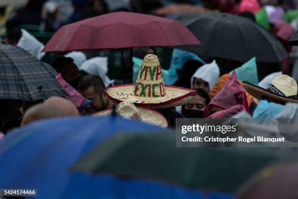 Person wears a hat that says Viva Mexico during the annual shout of independence as part of Mexico's Independence Day celebrations at Zocalo on...