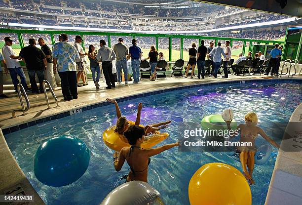 Girls swim in the Clevlander pool during Opening Day between the Miami Marlins and the St. Louis Cardinals at Marlins Park on April 4, 2012 in Miami,...