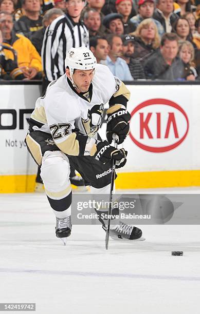 Craig Adams of the Pittsburgh Penguins skates with the puck against the Boston Bruins at the TD Garden on April 3, 2012 in Boston, Massachusetts.