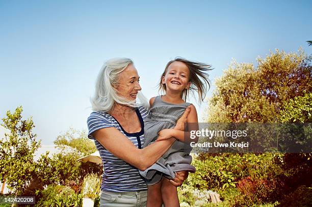 grandmother and granddaughter having fun - grandmother and grandchild stock-fotos und bilder