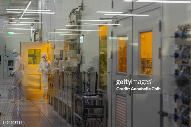 Students wear cleanroom suit conduct a research inside the clean room of Taiwan Semiconductor Research Institution during a press semiconductor tour...