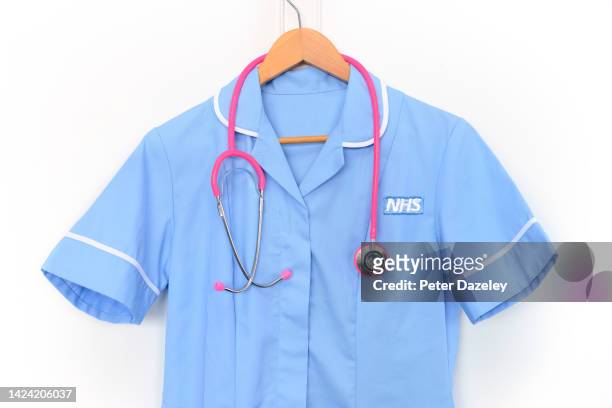 In this photo illustration, Medical scrubs with NHS logo hanging on September 14,2022 in London, England.