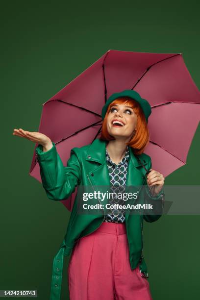 beautiful emotional woman holding umbrella - female fashion with umbrella stock pictures, royalty-free photos & images