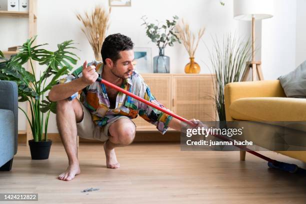 man cleaning the floor with broom. - scopa foto e immagini stock