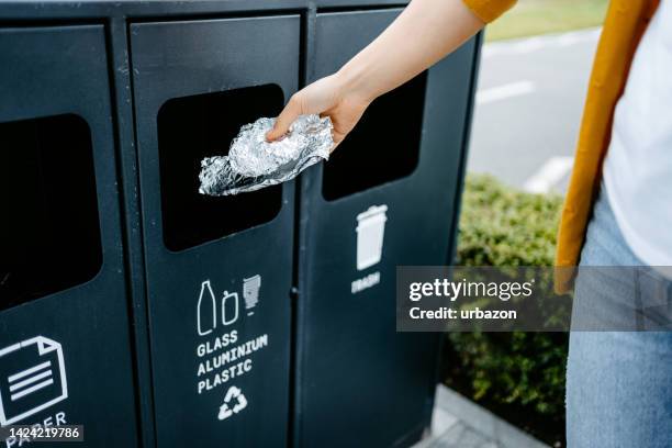 young woman recycling aluminum foil - white garbage can stock pictures, royalty-free photos & images