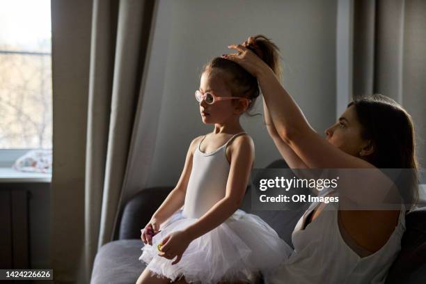 mother doing the hair of daughter wearing tutu - ballet dancers russia bildbanksfoton och bilder