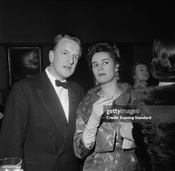 English opera singer Peter Pears , wearing a tuxedo with a bow tie, and Austrian-born British pianist Marion Stein , wearing an embroidered silk suit...