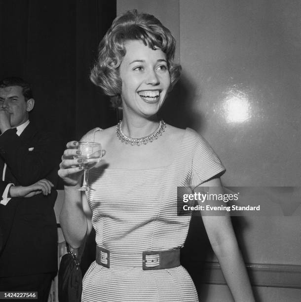 British television presenter Valerie Pitts , wearing a collar necklace with a square neckline outfit, holding a wineglass at an event, United...