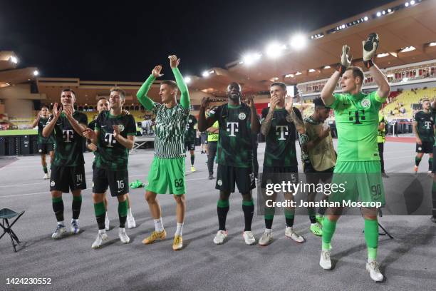 Ferencvarosi players celebrate in front of fans following the final whistle of the UEFA Europa League group H match between AS Monaco and...