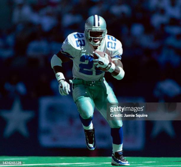 Emmitt Smith, Running Back for the Dallas Cowboys in motion running the football during the National Football Conference East Division game against...