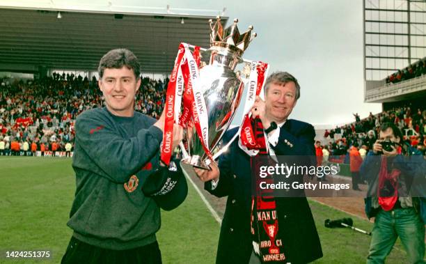 Manchester United coach Brian Kidd and manager Alex Ferguson lift the Carling Premier League trophy after the final match of the 1995/96 season...