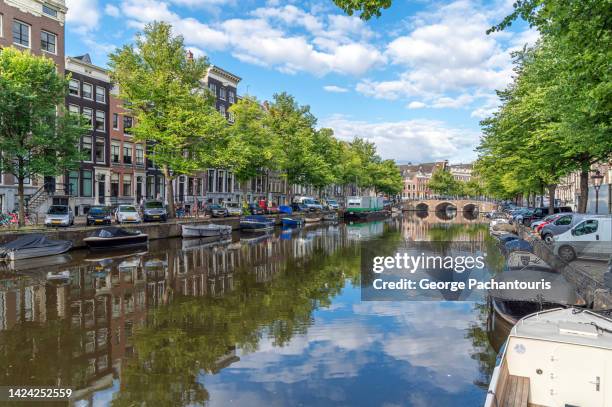 calm canal in amsterdam, holland - amsterdam canal stock pictures, royalty-free photos & images