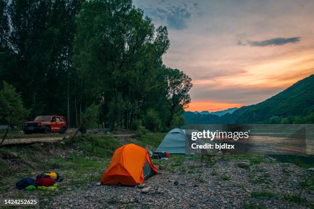 camp by the river in the setting sun - sunday in the valley stock pictures, royalty-free photos & images