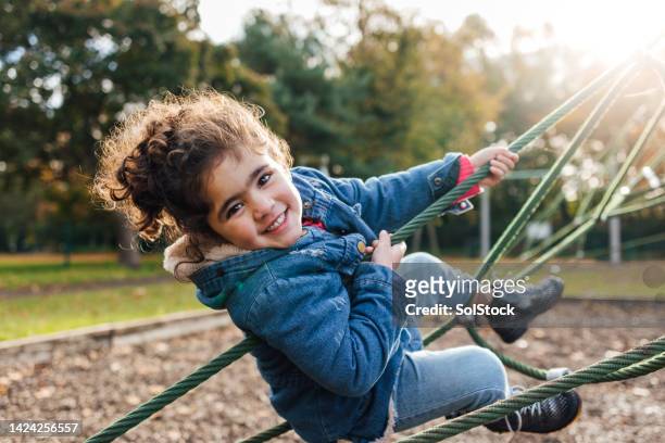 swinging in the sun - jungle gym stock pictures, royalty-free photos & images