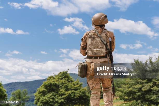 female soldier goes on position - ukraine people stock pictures, royalty-free photos & images