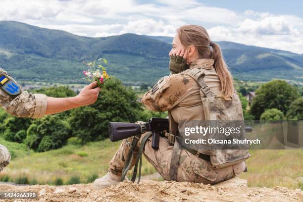 male soldier gives female soldier flowers - first ukrainian army stock pictures, royalty-free photos & images