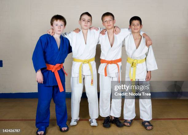 four boys in judo kit. - child judo stock pictures, royalty-free photos & images