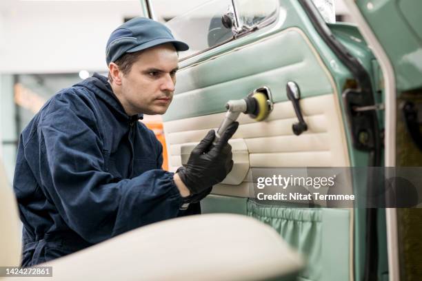 we restoring and polish scratches from behind your door handles. an auto mechanic is polishing the inside of the door handle with a soft polishing machine in an auto care service center. - car restoration stock pictures, royalty-free photos & images