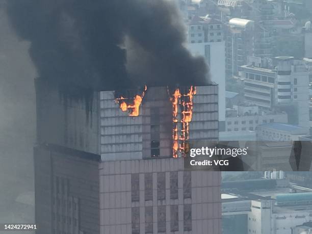 Flames and smoke rise from a 218-meter-tall office building on September 16, 2022 in Changsha, Hunan Province of China. A major fire broke out in the...