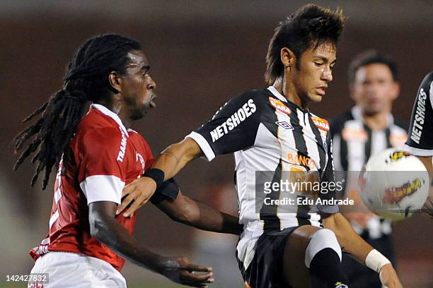 Tinga, from Internacional, fight for the ball with Neymar of Santos during a match between Internacional and Santos at Beira Rio stadium as part of...