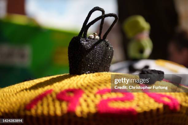 Crocheted model of Queen Elizabeth's handbag sits on top of a post box outside Windsor Castle on September 16, 2022 in Windsor, United Kingdom. Queen...