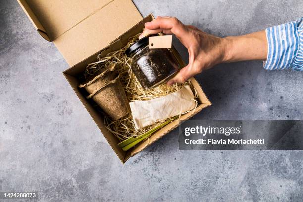 hands unboxing a planting set - seed packet stock pictures, royalty-free photos & images