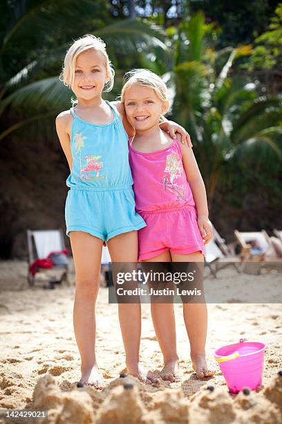 girls standing in front of sand castle on beach - jalisco (staat) stockfoto's en -beelden